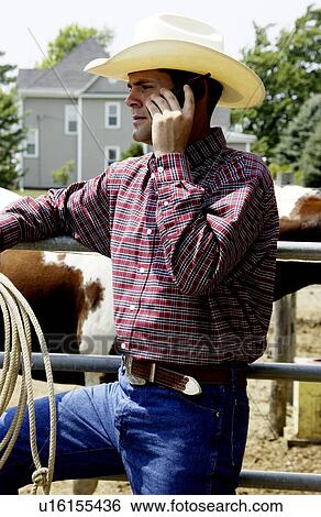 Rancher talking on cell phone View Large Photo Image Stock Photograph - Rancher talking on cell phone. Fotosearch