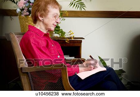 Stock Photo - Senior woman writing a letter. Fotosearch