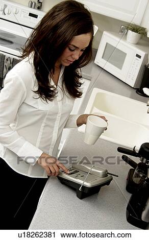 Stock Image - Woman checking phone messages. Fotosearch