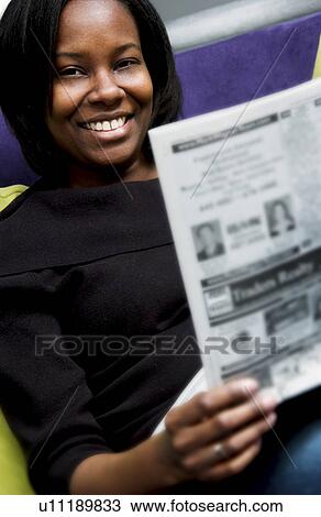 Stock Image - Woman reading newspaper. Fotosearch