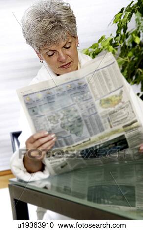 Woman reading newspaper View Large Photo Image Stock Image - Woman reading newspaper. Fotosearch