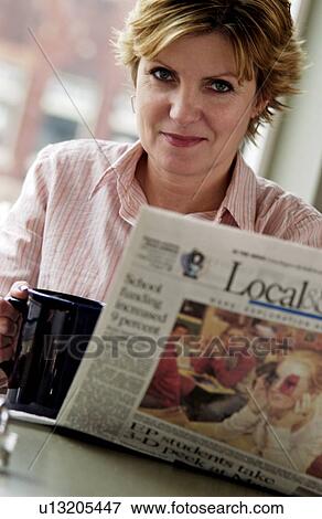 Woman reading newspaper View Large Photo Image Stock Photo - Woman reading newspaper. Fotosearch