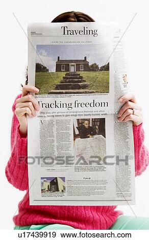 Stock Photo - Woman reading newspaper. Fotosearch