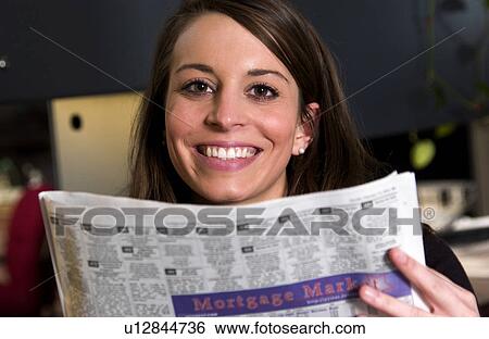 Stock Photograph - Woman reading newspaper. Fotosearch
