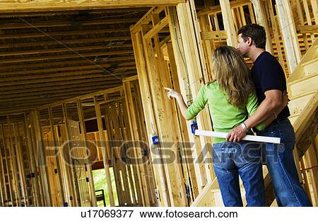 Couple building home View Large Photo Image Stock Photo - Couple building home. Fotosearch