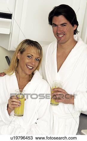 Couple drinking orange juice View Large Photo Image Stock Image - Couple drinking orange juice. Fotosearch