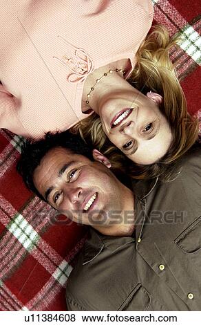 Couple laying on red and white checked blanket View Large Photo Image Stock Photo - Couple laying on red and white checked blanket. Fotosearch