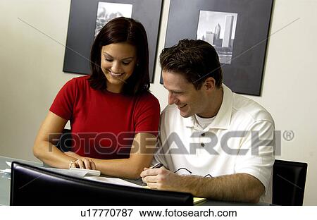 Stock Photo - Couple looking over bills. Fotosearch