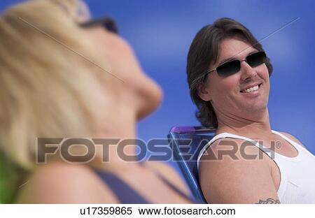 Couple lying out in the sun View Large Photo Image Stock Photography - Couple lying out in the sun. Fotosearch