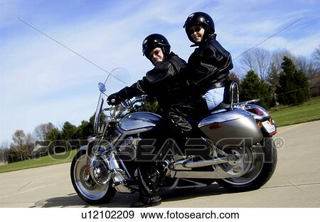 Stock Photo - Couple on motorcycle. Fotosearch