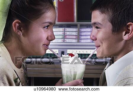 Couple sharing a soda View Large Photo Image Stock Image - Couple sharing a soda. Fotosearch