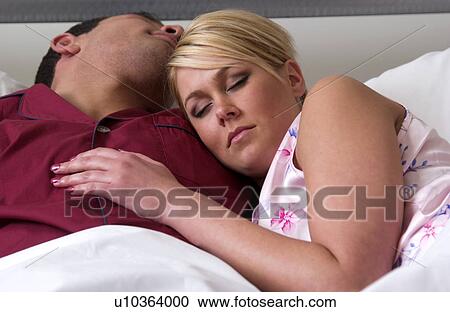 Couple sleeping in bed View Large Photo Image Stock Image - Couple sleeping in bed. Fotosearch