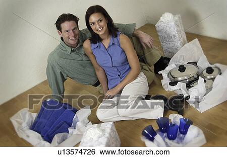 Couple wrapping gifts View Large Photo Image Stock Photograph - Couple wrapping gifts. Fotosearch