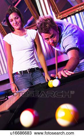 Young adults at a nightclub playing pool View Large Photo Image Stock Image - Young adults at a nightclub playing pool. Fotosearch