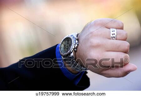 Stock Photo - Businessman checking his watch. Fotosearch