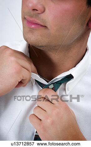 Stock Photo - Businessman loosening his tie. Fotosearch