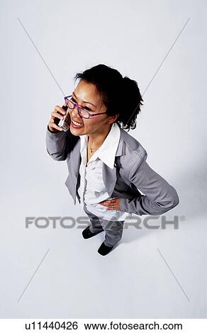 Stock Photograph - Businesswoman on cell phone . Fotosearch