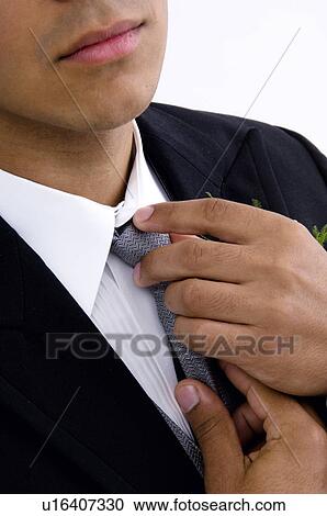 Man fixing tie View Large Photo Image Stock Image - Man fixing tie. Fotosearch