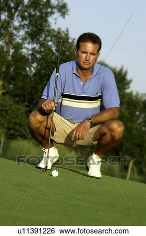 Stock Photograph - Man looking at shot playing golf. Fotosearch