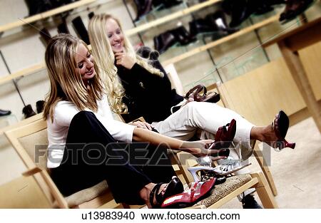 Two women in shoe store View Large Photo Image Stock Image - Two women in shoe store. Fotosearch