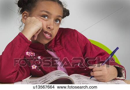 Picture - African American girl doing homework. Fotosearch