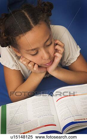 Stock Photography - African American girl doing homeworkv. Fotosearch