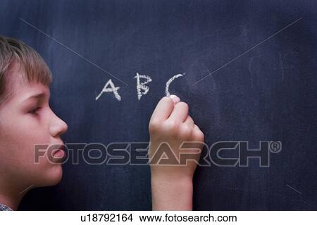 Boy at chalkboard View Large Photo Image Picture - Boy at chalkboard. Fotosearch