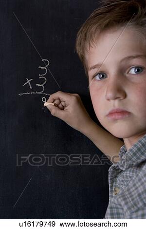 Boy at chalkboard View Large Photo Image Stock Photo - Boy at chalkboard. Fotosearch