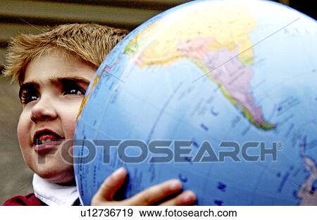 Stock Photo - Boy holding globe. Fotosearch