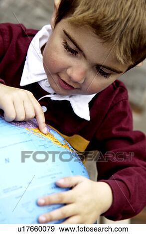 Stock Photo - Boy looking at globe. Fotosearch
