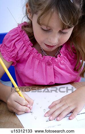 Stock Image - Girl doing homework. Fotosearch