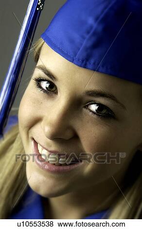 Stock Photo - Girl in cap and gown for graduation. Fotosearch