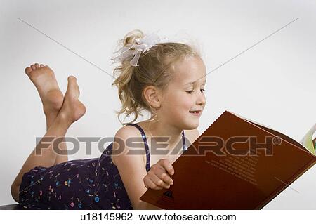 Stock Image - Girl reading book. Fotosearch