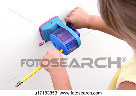 Girl sharpening pencil View Large Photo Image Stock Image - Girl sharpening pencil. Fotosearch