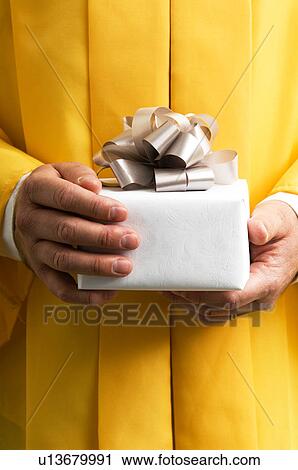 Graduate holding a gift View Large Photo Image Stock Image - Graduate holding a gift. Fotosearch