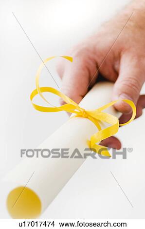 Picture - Graduate holding diploma. Fotosearch