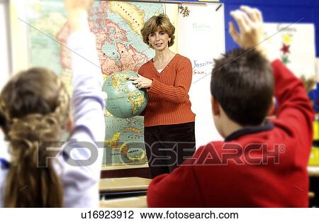Stock Image - Teacher teaching class. Fotosearch