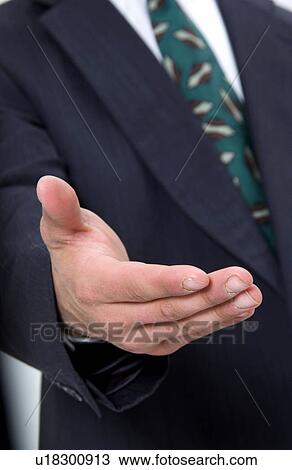Businessman holding out his hand to shake hands View Large Photo Image Stock Image - Businessman holding out his hand to shake hands. Fotosearch
