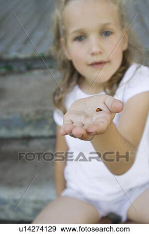 Girl holding ladybug View Large Photo Image Stock Photo - Girl holding ladybug. Fotosearch