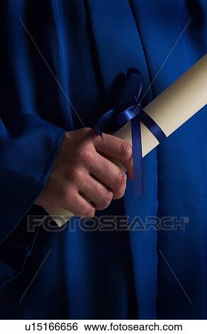 Graduate holding diploma View Large Photo Image Stock Photograph - Graduate holding diploma. Fotosearch