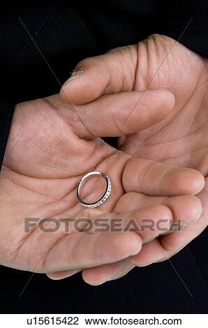 Stock Image - Groom holding hands behind back. Fotosearch