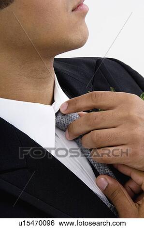 Man fixing tie View Large Photo Image Stock Photograph - Man fixing tie. Fotosearch
