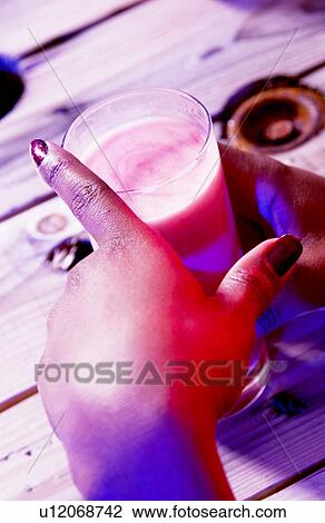 Stock Image - Person holding alcoholic drink Person holding alcoholic drink . Fotosearch
