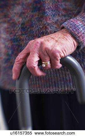 Stock Photography - Senior womans hands on cane. Fotosearch