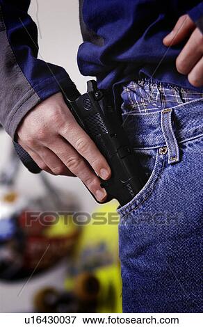 Teen putting gun in his pocket View Large Photo Image Stock Photo - Teen putting gun in his pocket. Fotosearch