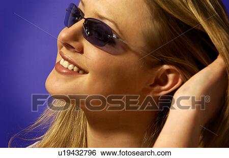 Stock Photograph - Girl wearing sunglasses. Fotosearch