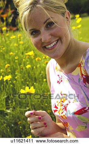 Stock Image - Woman in field of flowers. Fotosearch
