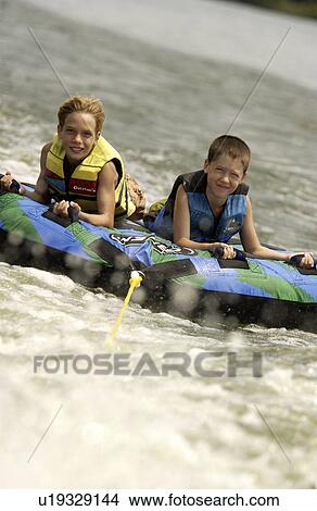 Boys on inner tube View Large Photo Image Picture - Boys on inner tube. Fotosearch