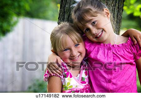 Girls with arms around each other View Large Photo Image Stock Image - Girls with arms around each other. Fotosearch