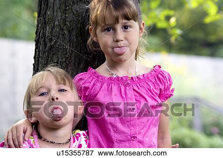 Stock Photo - Girls with arms around each other. Fotosearch